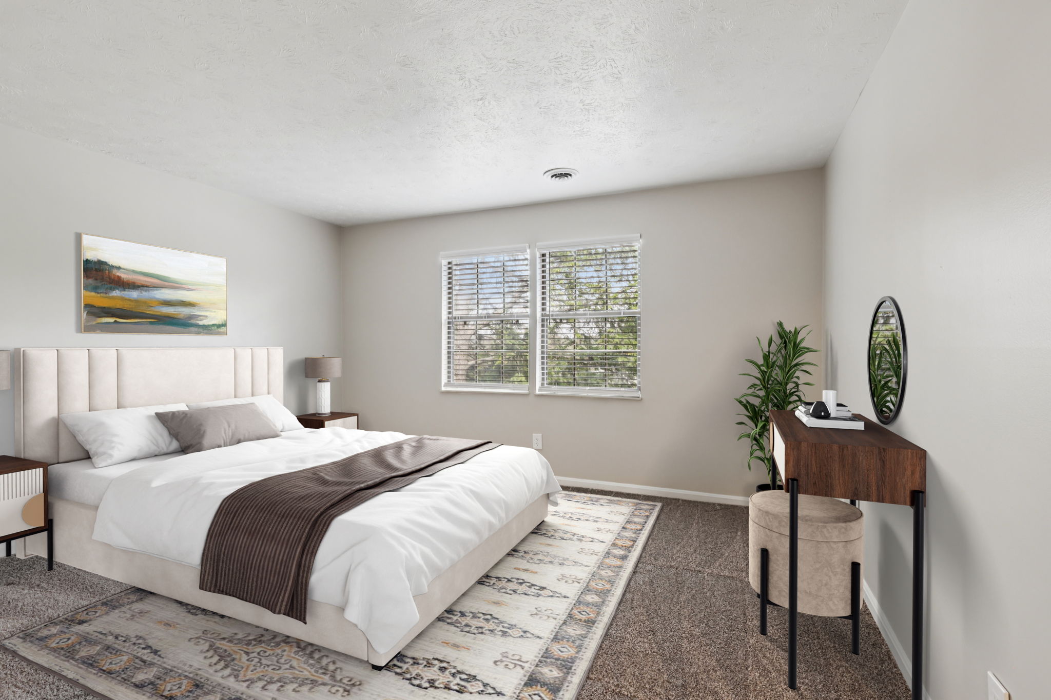 A bedroom with a large bed and a desk with a plant on it.